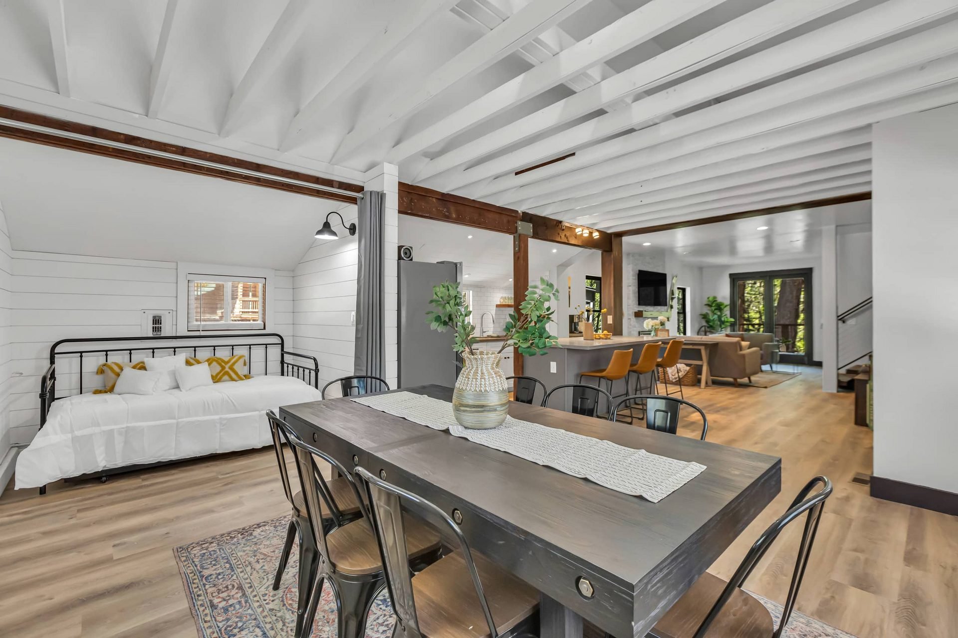 Dining table and open-plan interior with kitchen and living room beyond